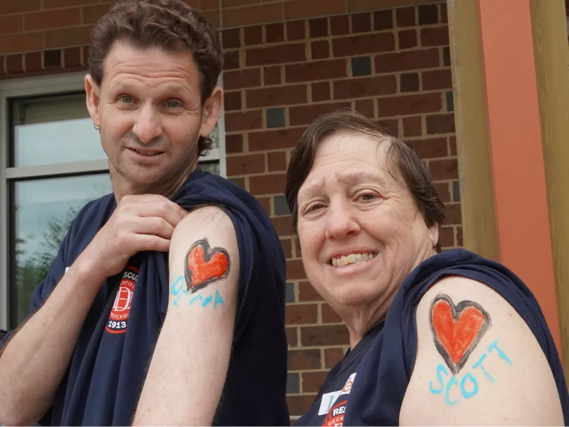 CEL members smiling while wearing matching body paint during Community Day.