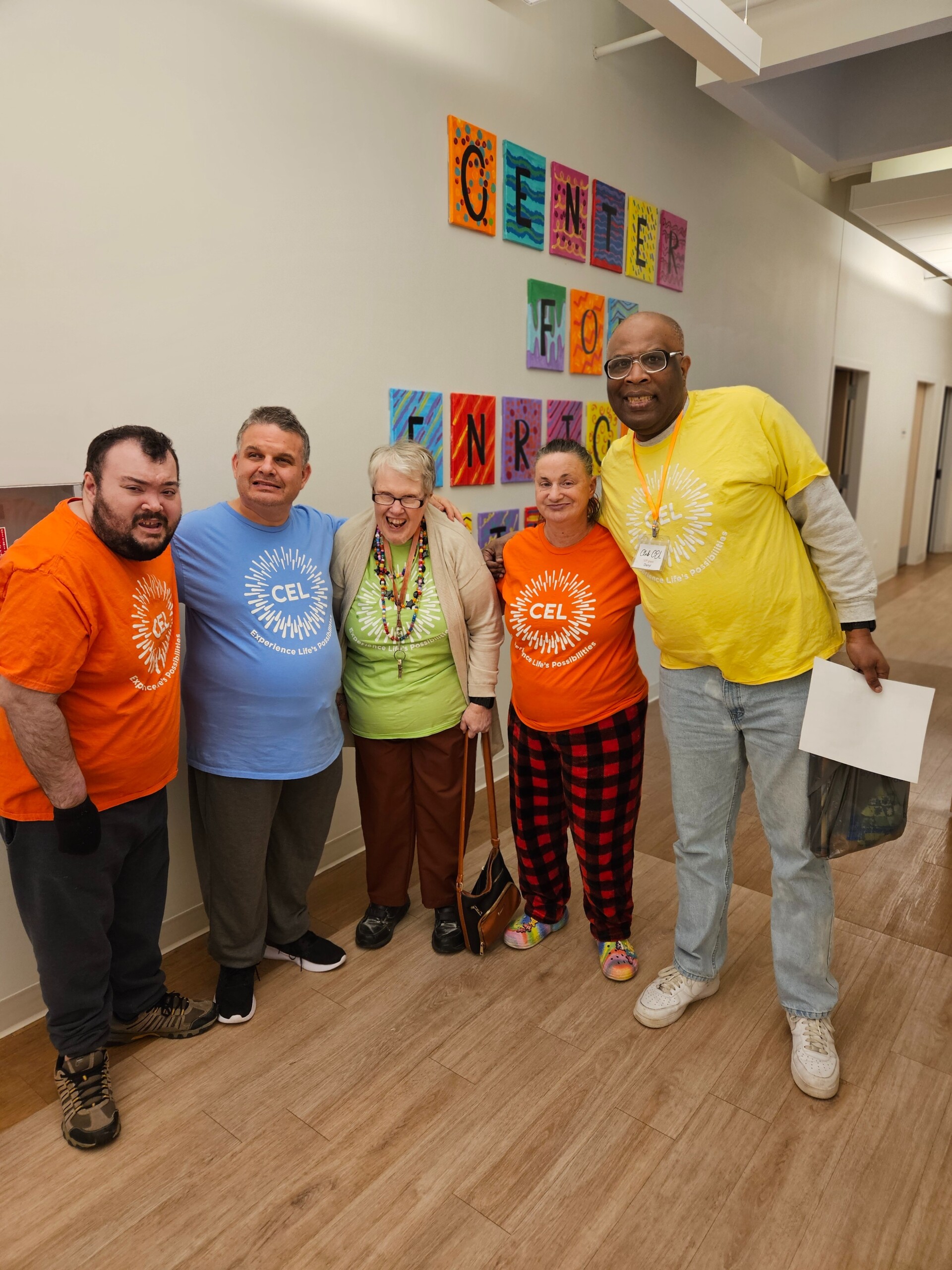 A photo of CEL members smiling with friends in CEL merch.