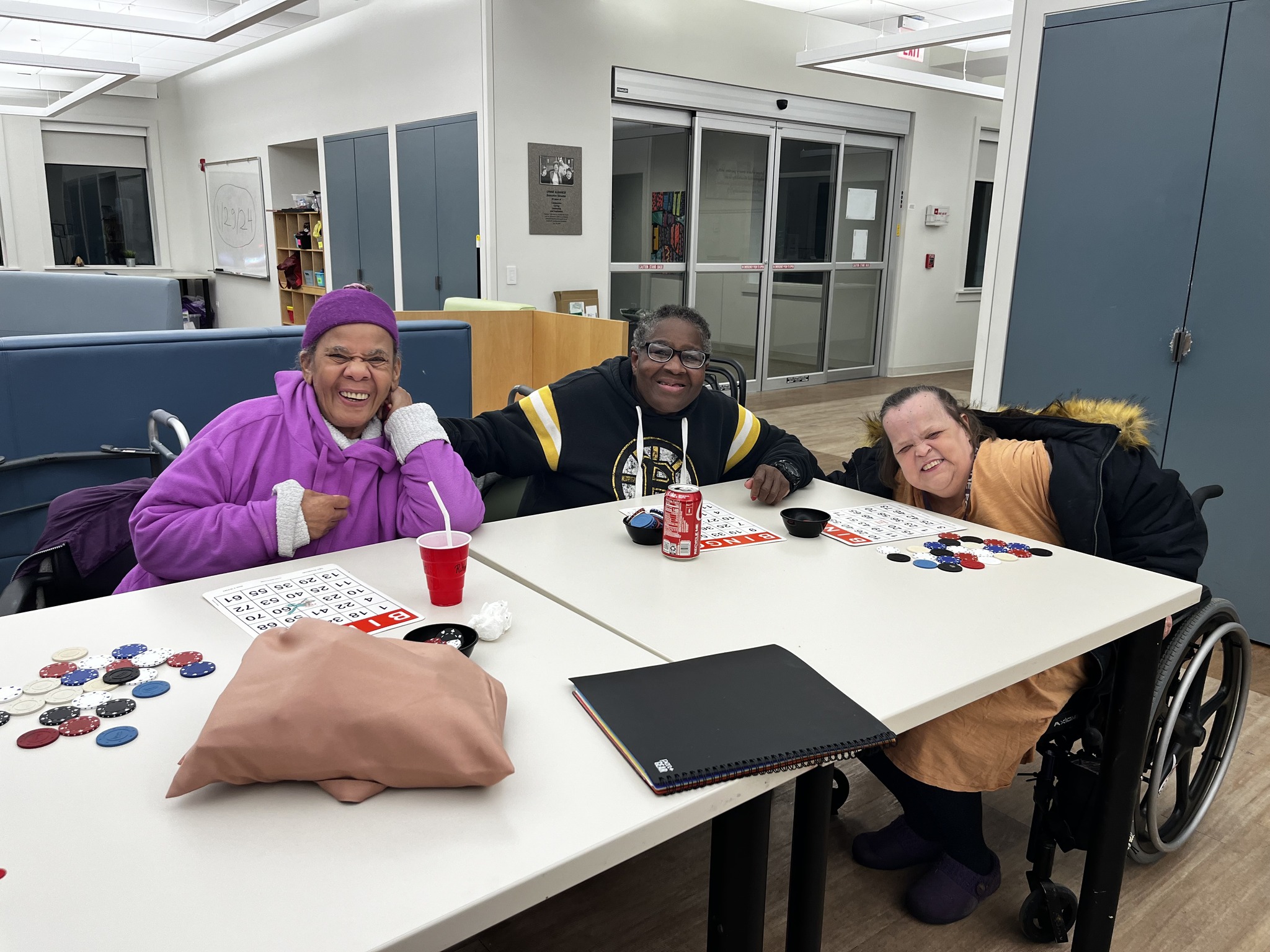 A group of CEL members smiling while playing Bingo during Wednesday Night Sampler.