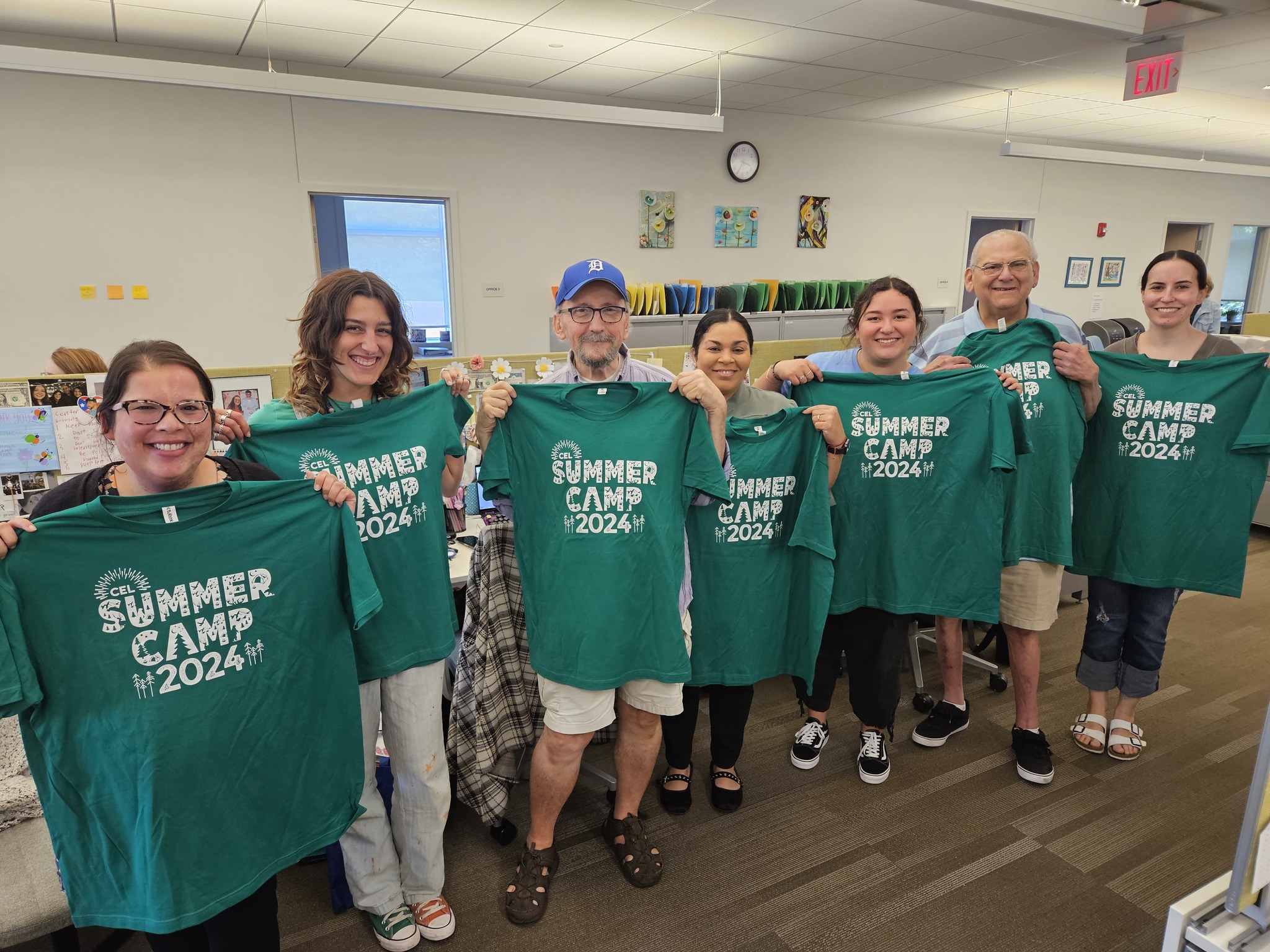 A photo of CEL members posing with Summer Camp Merch.