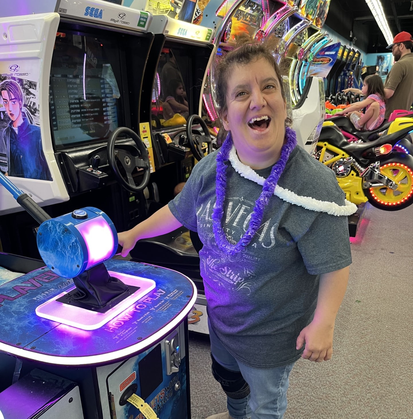 REACH member Smadar smiling as she plays game during nickel city excursion.